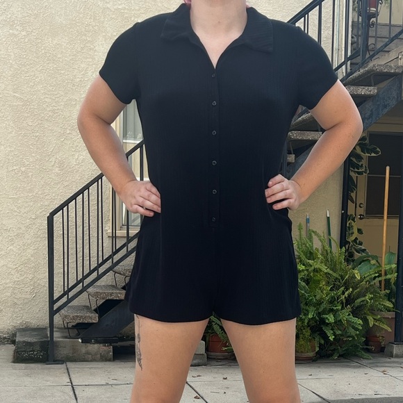 Black short sleeve and pant onesie romper with a button up front. - Picture 2 of 6